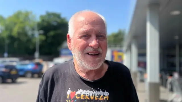 A man in a black t-shirt.