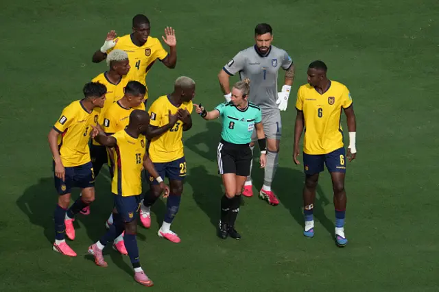 Ecuador's players argue with US referee Tori Penso
