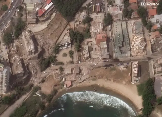 Vantor satellite image shows collapsed apartment buildings and damaged structures in Playa Puerto Viejo neighborhood of La Guaira following a devastating earthquake.