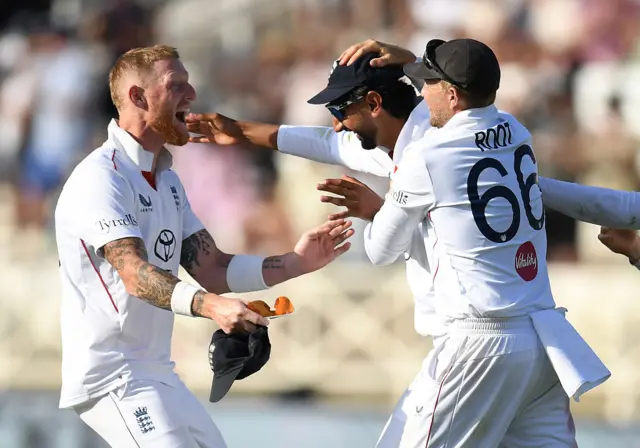 Root, Bashir and Stokes celebrate wicket.