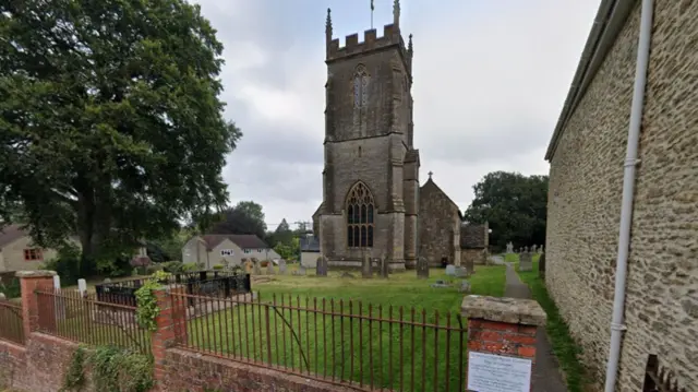 A street view image of St Nicholas' Church with a cemetery outside the front.