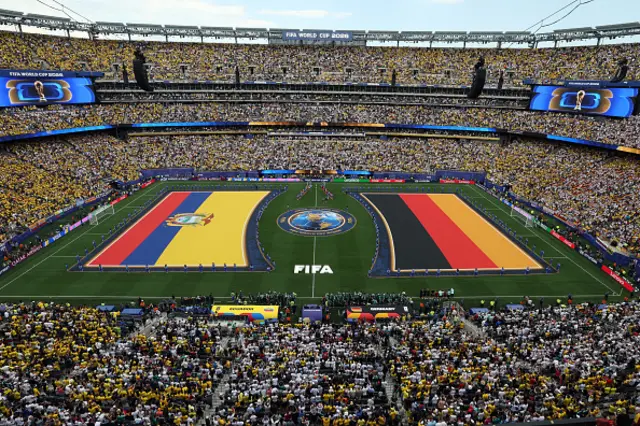 Ecuador and German players stand for the national anthem