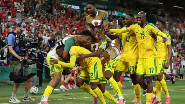 Thapelo Maseko of South Africa celebrates with teammates after scoring the team's first goal during the FIFA World Cup 2026 Group A match between South Africa and Korea Republic.