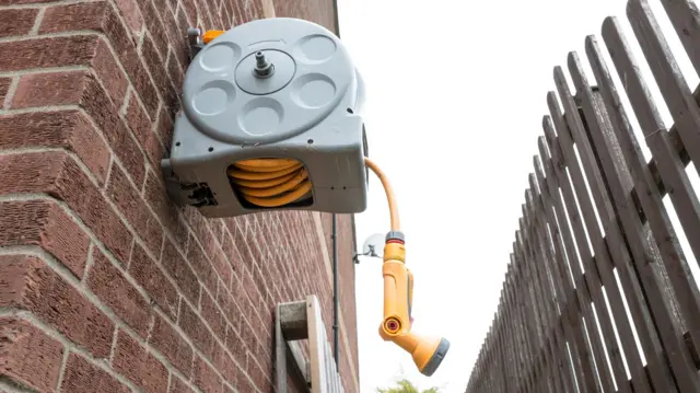 A hose is hanging outside a house.
