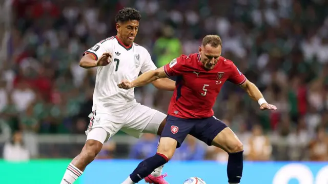 MEXICO CITYVladimir Coufal #5 of Czechia controls the ball against Luis Romo #7 of Mexico during the FIFA World Cup 2026 Group A match between Czechia and Mexico at Mexico City Stadium.