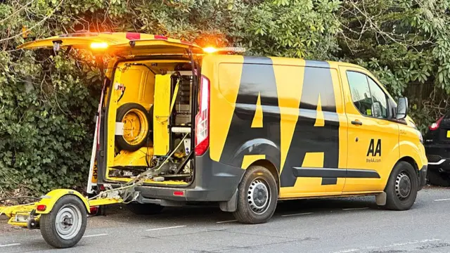 A yellow AA van