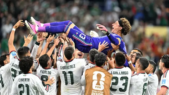 Mexico's players lift up goalkeeper #13 Guillermo Ochoa after winning the 2026 World Cup Group A football match between the Czech Republic and Mexico.