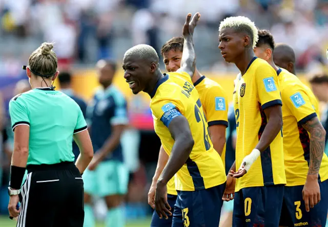 Ecuador players surround the referee