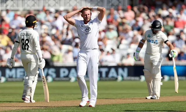 England's Gus Atkinson-hands on head, after a missed catch.