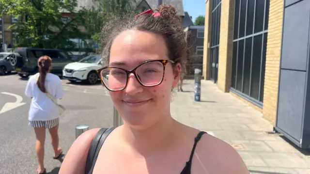 A woman smiles.