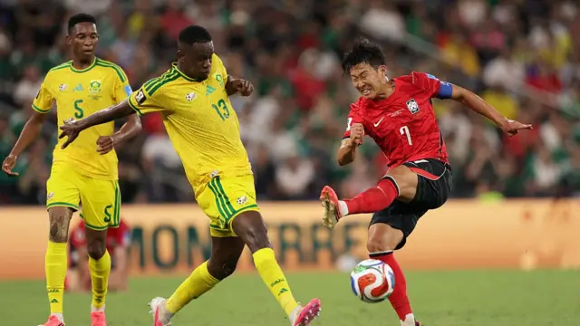 South Korea's forward #07 Son Heung-min misses to kick the ball as he's defended by South Africa's midfielder #13 Sphephelo Sithole during the 2026 World Cup Group A football match between South Africa and South Korea.