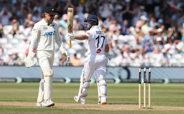 Ben Duckett raises bat in celebration of reaching 50 runs