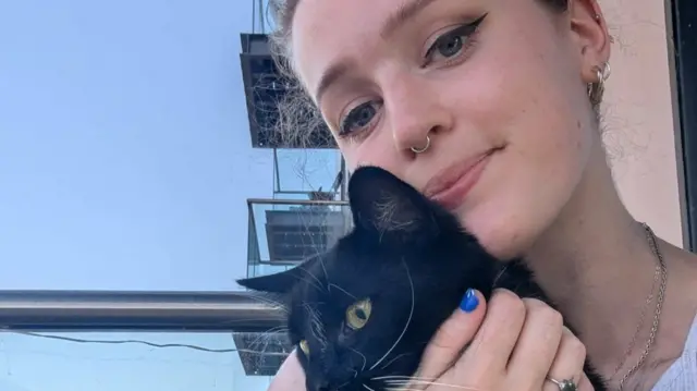 Emilia on her balcony with her cat Reggie
