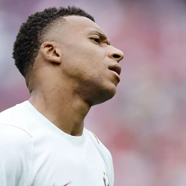 Mbappe reacts to his early shot off the bar