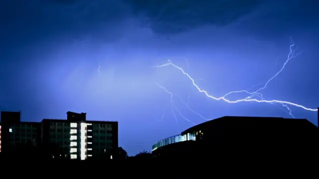 Forked lightning pictured over Bristol buildings at night