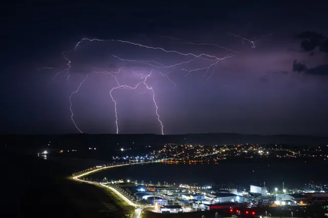 Lightning strikes are seen during a storm over Weymouth, on June 25, 2026