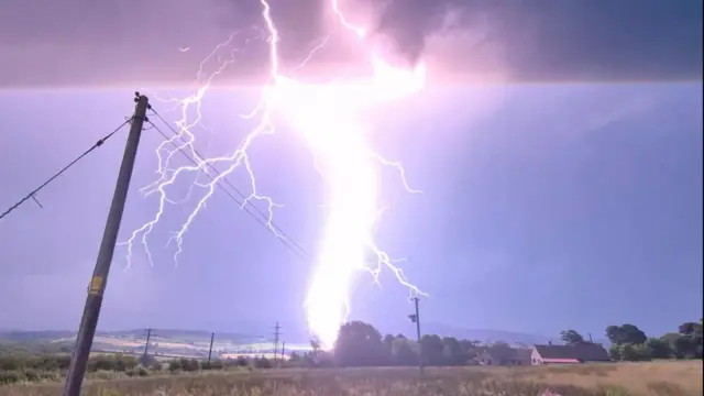 Large bolt of lightning seen above fields