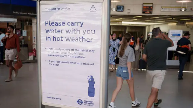 a notice telling rail passengers to carry water with them, is at Blackfriars Station in the City of London, the capital's financial district, on 25th June 2026