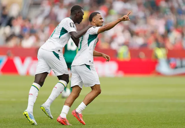 Iliman Ndiaye #13 of Senegal celebrates with teammate Pape Gueye