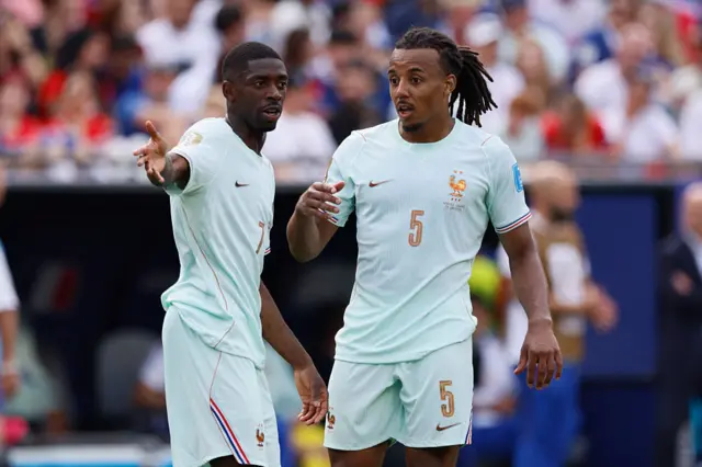 Ousmane Dembele and Jules Kounde of France discuss tactics