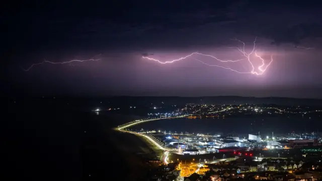 Lightning strikes are seen during a storm over Weymouth, on June 25, 2026
