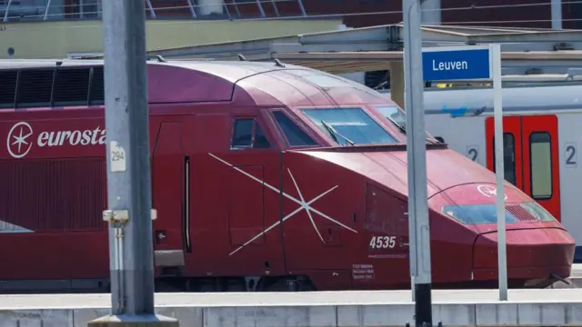 A red Eurostar train on a platform