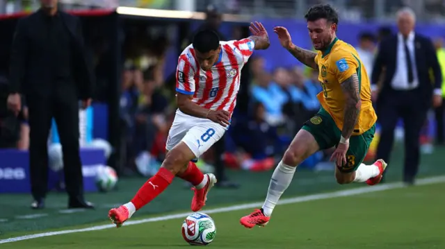 SANTADiego Gomez of Paraguay is challenged by Aiden O'Neill #13 of Australia during the FIFA World Cup 2026 Group D match between Paraguay and Australia.