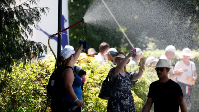 A group of people are sprayed with water