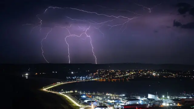 Lightning strikes are seen during a storm over Weymouth, on June 25, 2026 in Portland, United Kingdom