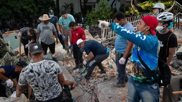 Rescue workers work at the scene in an earthquake-affected area of Caracas, Venezuela