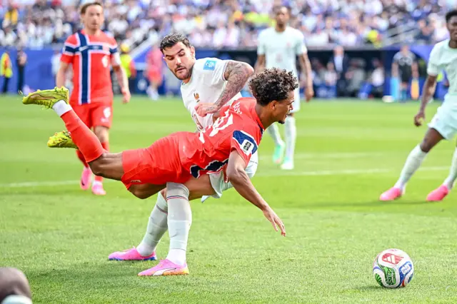 Theo Hernandez of France and Oscar Bobb of Norway battle for the ball