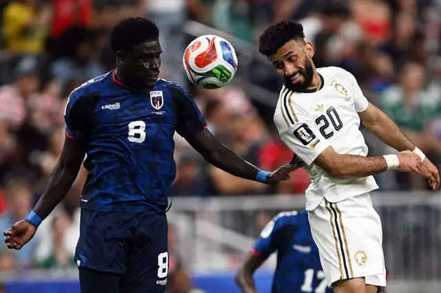 Cape Verde's defender #08 Joao Paulo (L) and Saudi Arabia's midfielder #20 Sultan Mandash jump for the ball