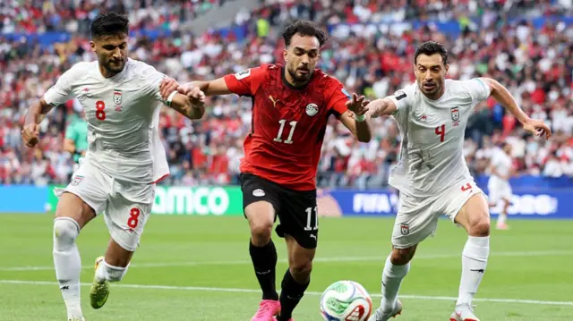 Mostafa Zico of Egypt competes for the ball against Mohammad Mohebbi and Shoja Khalilzadeh of Iran