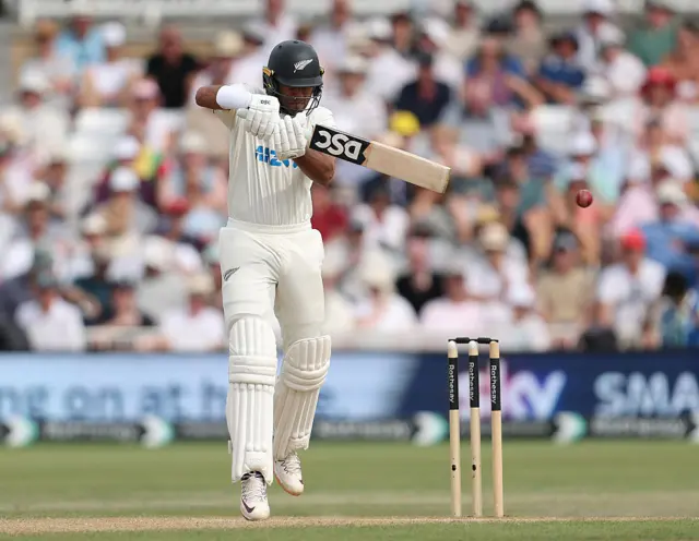 Racin Ravindra of New Zealand drives the ball to the boundar