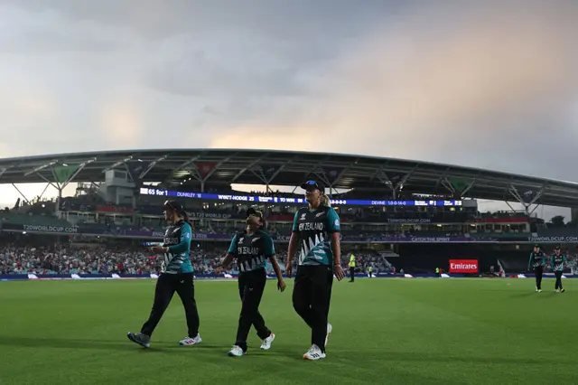 New Zealand players leave field after rain stops play