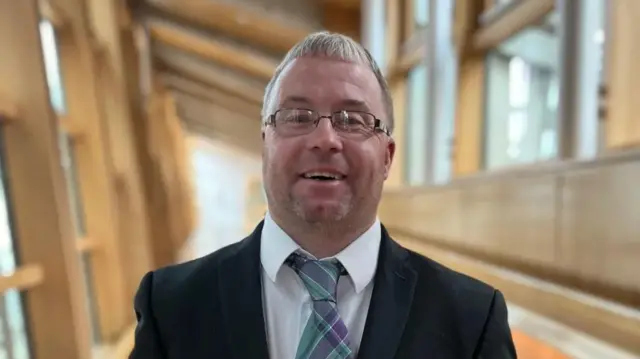 Mace bearer Robert White is usually the Scottish Parliament's postman