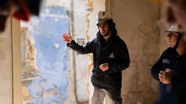 Josh Macabuag pictured at work previously wearing hard hat