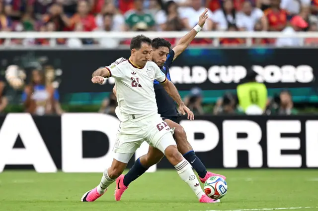 Spain's forward #21 Mikel Oyarzabal and Uruguay's defender #03 Sebastian Caceres fight for the ball