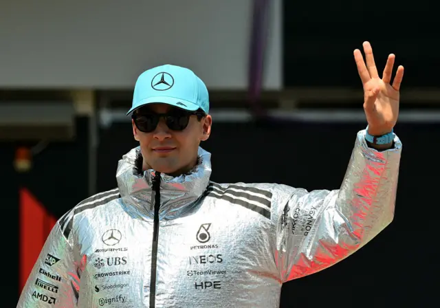 George Russell arrives at the 2026 Austrian Grand Prix wearing a large foil coat