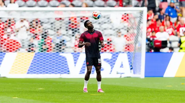 Alphonso Davies doing kick ups with the ball in Canada training kit