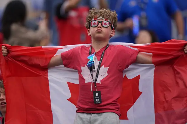 A Canada fan holding a national flag