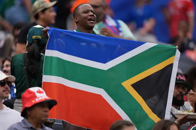 A South Africa fan holding their flag upside down