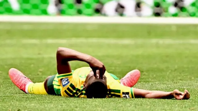 South Africa defender Aubrey Modiba (6) lays on the pitch after Canada defeated South Africa.