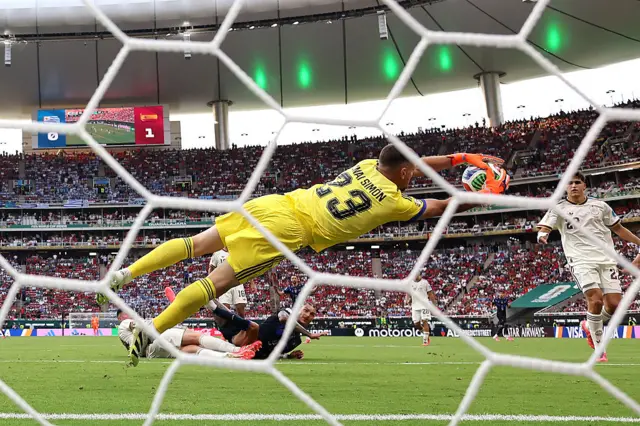 Spain goalkeeper Unai Simón dives to make a save during the Group H match against Uruguay at the 2026 World Cup