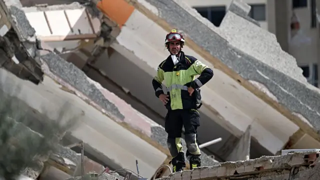 A Spanish rescuer stands on the rubble of a collapsed building in Catia La Mar, La Guaira state