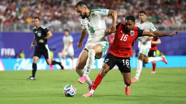 Nabil Bentaleb is challenged by Phillip Mwene
