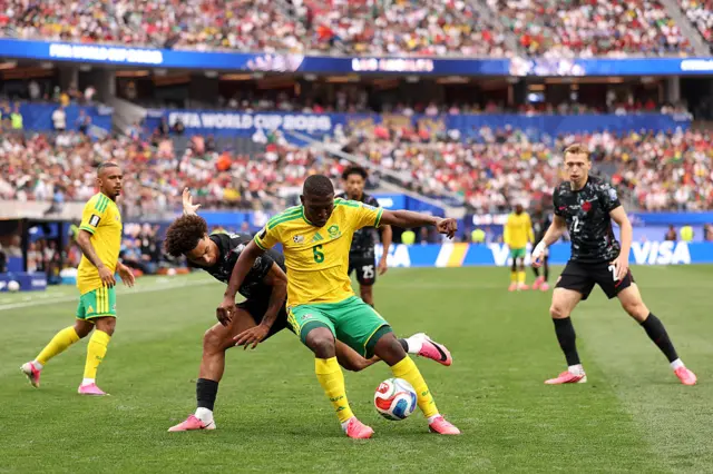 Aubrey Modiba and Tajon Buchanan battle for the ball