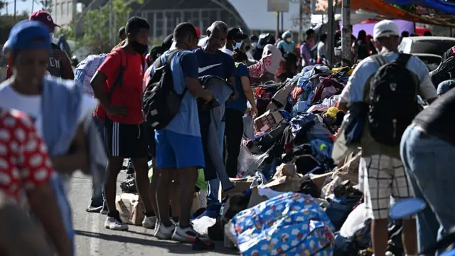Residents sort through piles of donated clothing in Catia La Mar, La Guaira state
