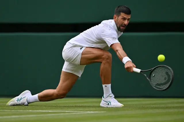 Novak Djokovic returns the ball