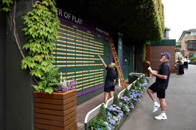 Wimbledon staff doing the order of play for day 1 at the Championships